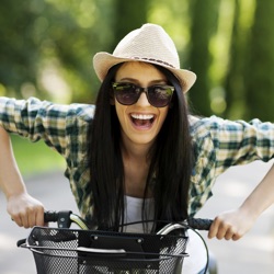 Smiling Woman with Sunglasses on Bike