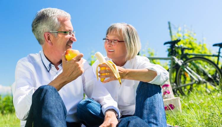 Senior Couple Snacking Outside