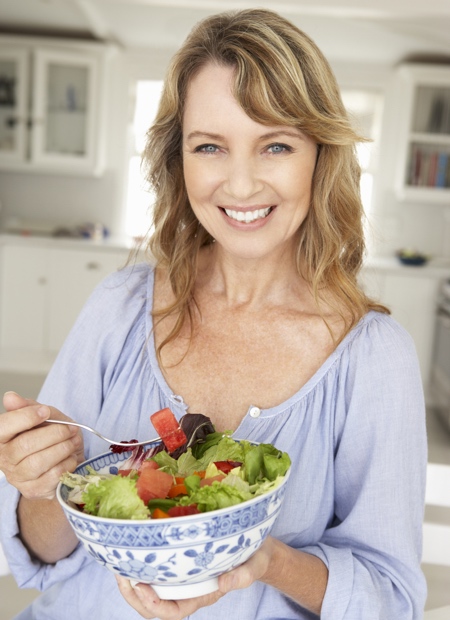 Woman Eating Fresh Leafy Greens and Berry Salad