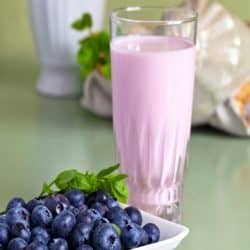 blueberry yogurt smoothie and berries on table