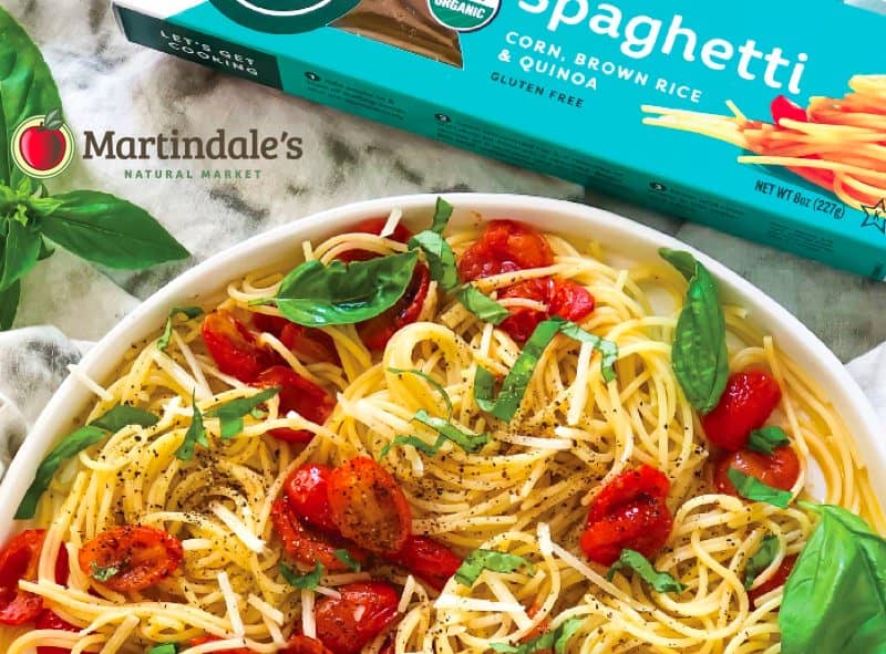 corn, brown rice, and quinoa pasta with tomatoes, basil, pepper on kitchen counter