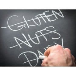 list of multiple food allergies on chalkboard, each one being crossed out