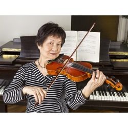 Lady attentively playing violin