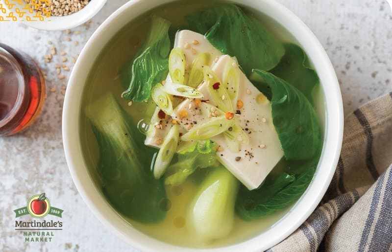 Soup with miso paste, baby bok choy, kombu, green onion, and silken tofu