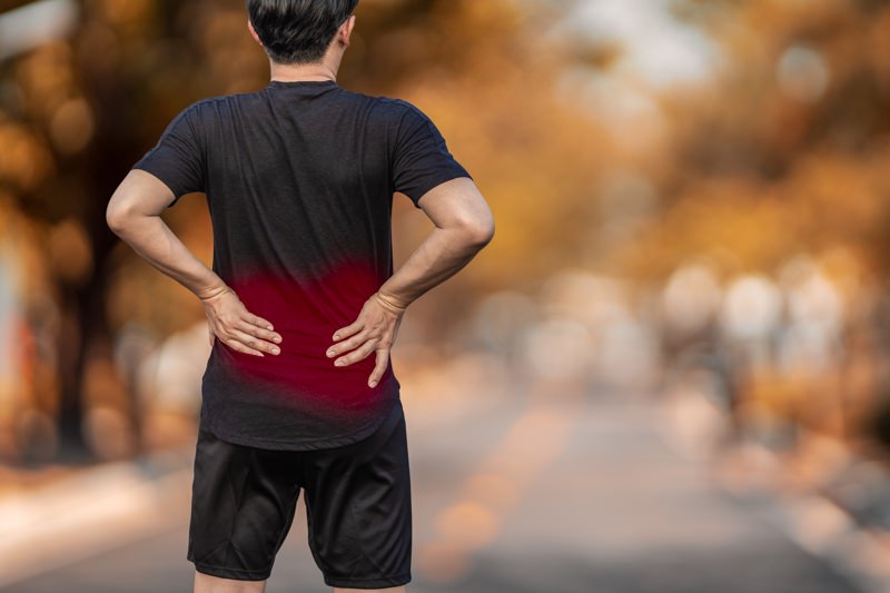 Man with osteoarthritis pain in lower back 