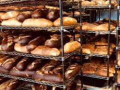 A variety of fresh bread loaves on racks from LeBus Bakery