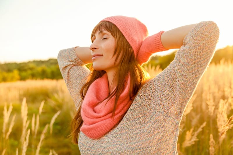 person standing outside looking tranquil in body and mind