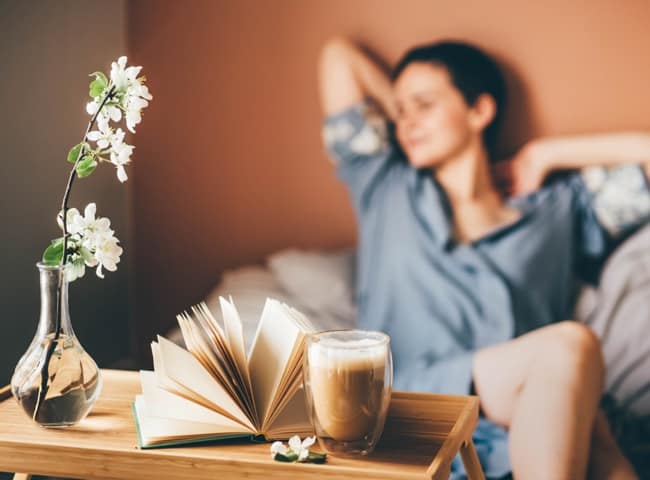 A woman relaxes with a caffeine-free coffee alternative